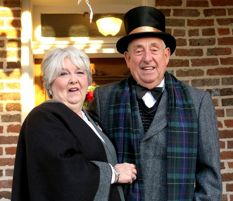 Bob and Sandy Kelley, of Gravette, dressed in vintage attire and played host and hostess as they greeted visitors to the historic Kindley home Saturday evening. The Kindley re-enactors helped add an authentic note to the &quot;Come Home for Christmas&quot; celebration inside the museum and on the grounds following the annual Christmas parade.