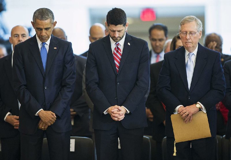 President Barack Obama and House Speaker Paul Ryan pause for a prayer Wednesday in Emancipation Hall during ceremonies marking the 150th anniversary of the 13th Amendment. 
