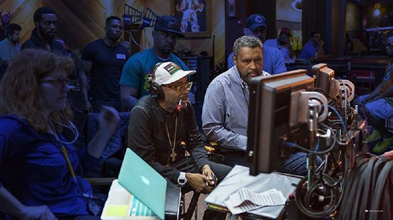 Spike Lee (left) and Kevin Willmott watch the playback of a scene from Chi-Raq, the new fi lm they’ve co-written about street violence in Chicago. The film, which is playing in Northwest Arkansas, is the first feature released by Amazon Studios and will be released On Demand soon.