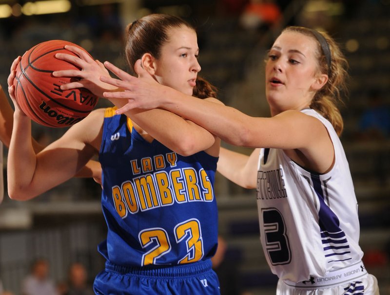 NWA Democrat-Gazette/ANDY SHUPE Grayce Spangler (3) of Fayetteville defends Thursday against Maly Tabor of Mountain Home during the first half at Bulldog Arena in Fayetteville. Visit nwadg.com/photos to see more photographs from the game.