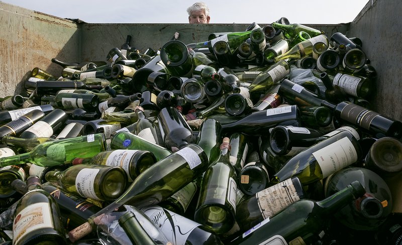 More than 500 bottles of counterfeit and unsellable wine are destroyed at the Texas Disposal Systems recycling and compost facility in Austin, Texas, on Thursday, Dec. 10, 2015. The wine is from the Rudy Kurniawan case, the man convicted of fraud in federal court in 2013 for producing and selling millions of dollars of counterfeit wine. 