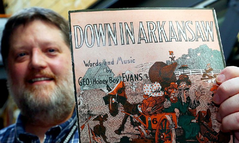 John Miller, music coordinator for Arkansas Sounds, shows off an example of the sheet music in a collection at the Butler Center for Arkansas Studies. The collection, donated by Ron Robinson, has many examples of music and illustrations that show how the world viewed Arkansas.