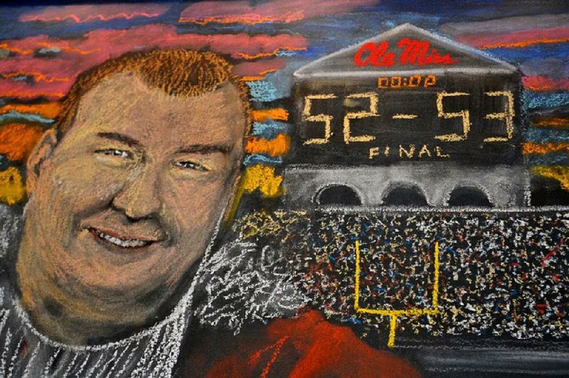 A likeness of Arkansas Coach Bret Bielema and the score of the Arkansas-Ole Miss game adorns the wall of a brewery in Tuscaloosa, Ala. Arkansas’ victory allowed Alabama to win the SEC West and advance to the College Football Playoff.
