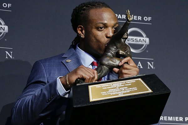 Alabama's Derrick Henry kisses the Heisman Trophy while posing for photos after winning the award as the country's top college football player, Saturday, Dec. 12, 2015, in New York. (AP Photo/Julie Jacobson)
