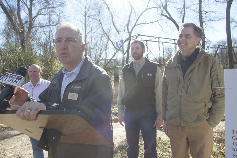 Garland County Judge Rick Davis (from left), Saline County Judge Jeff Arey, state Highway Department Director Scott Bennett and U.S. Rep. French Hill, R-Ark., hold a news conference Monday in Benton to discuss a $500,000 grant to help restore the historic Old River Bridge.