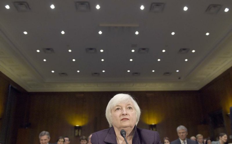 Federal Reserve Chairman Janet Yellen prepares to testify on Capitol Hill in Washington in February. Analysts expect the Fed will raise interest rates today from record lows. 