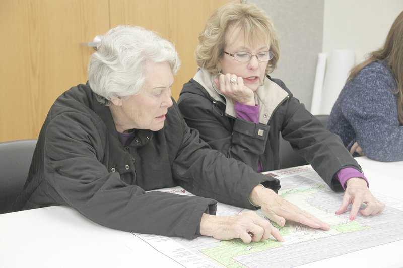 LYNN KUTTER ENTERPRISE-LEADER Farmington City Council members Patsy Pike and Diane Bryant look over a master site plan for Creekside Park. The council held a work session to discuss priorities for park improvements.