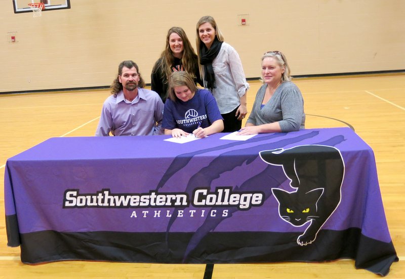 Photo by Susan Holland Amanda Pinter, a senior at Gravette High School, signed last Friday to play volleyball at Southwestern College in Winfield, Kan. She was joined at the signing by her parents, Stephen and Jodi Pinter, and Katie Collins (left, rear), her GHS volleyball coach, and Carolina Garbato, who will be her coach at Southwestern.