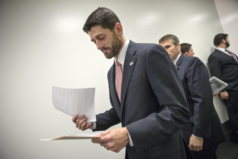 House Speaker Paul Ryan of Wis. looks over his notes before a news conference on Capitol Hill in Washington, Wednesday, Dec. 16, 2015, following a closed-door session with House Republicans as lawmakers work to complete end-of-the-year business and pass a comprehensive spending bill. Congressional leaders girded to push a Christmas compromise on tax cuts and spending through the House and Senate by week's end after Republicans and Democrats reached agreement on a legislative package extending dozens of tax breaks for businesses and families and financing 2016 government operations. (AP Photo/J. Scott Applewhite)
