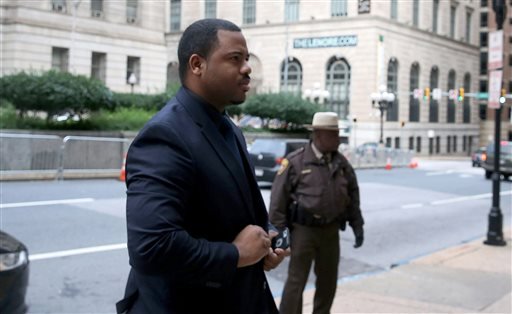 William Porter, left, one of six Baltimore city police officers charged in connection to the death of Freddie Gray, arrives at a courthouse as jury deliberations continue in his trial, Wednesday, Dec. 16, 2015, in Baltimore.