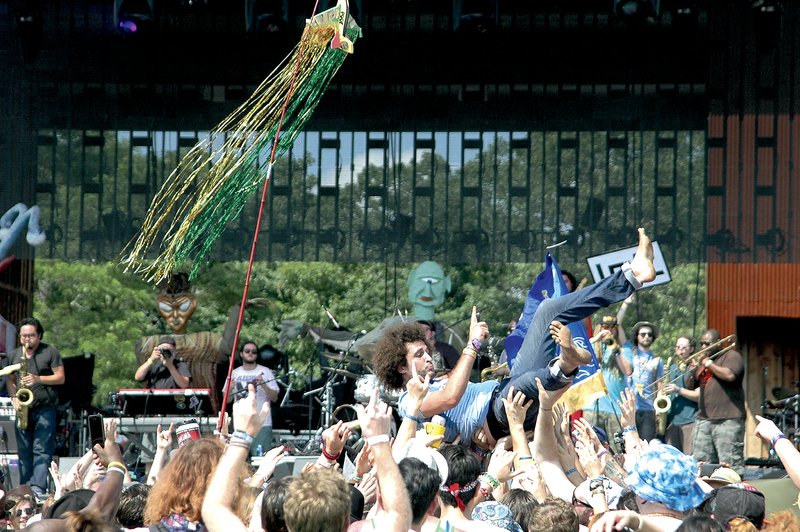 Hundreds of bands performed during the Wakarusa music festival, including Andy Frasco, center, crowd surfing, who kicked off the events on the festival's main stage.