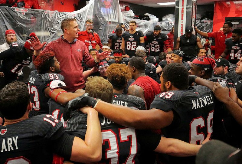 Arkansas State Coach Blake Anderson (left, standing) will lead the Red Wolves into today’s New Orleans Bowl against Louisiana Tech riding an eight-game winning streak. The second-year coach said the Red Wolves have been playing with a chip on their shoulders for most of the season because they felt like they weren’t getting enough respect not only within the conference but also on a national level.