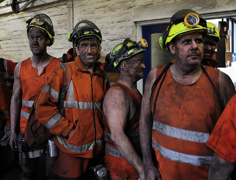 Miners come off the last shift at Kellingley Colliery in Knottingley, northern England, on the final day of production, Friday.