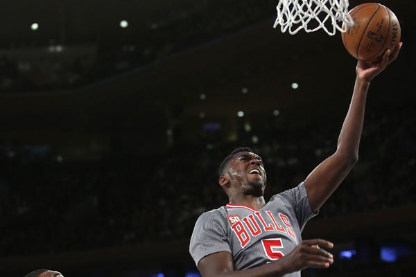 Chicago Bulls' Bobby Portis (5) goes to the basket against New York Knicks' Kyle O'Quinn (9) during the fourth quarter of an NBA basketball game Saturday, Dec. 19, 2015, in New York. New York defeated Chicago 107-91. (AP Photo/Jason DeCrow)