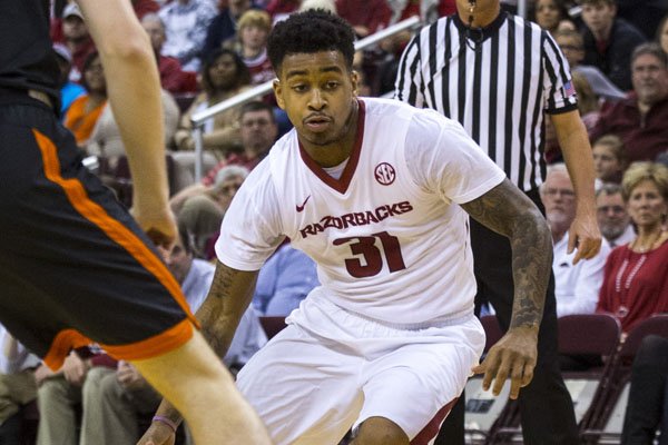 Arkansas guard Anton Beard dribbles up the middle of the court against Mercer at Verizon Arena in North Little Rock on Saturday, Dec. 19, 2015.