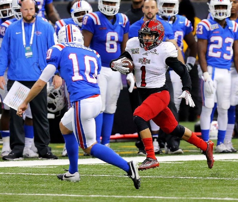 Arkansas State kick returner Blaise Taylor (1) runs past Louisiana Tech’s Jonathan Barnes en route to a 98-yard touchdown during the fourth quarter of Saturday’s New Orleans Bowl. Taylor’s score wasn’t enough to help the Red Wolves beat the Bulldogs, who finished with 687 yards of total offense in rolling to a 47-28 victory in front of 32,847 at the Superdome.