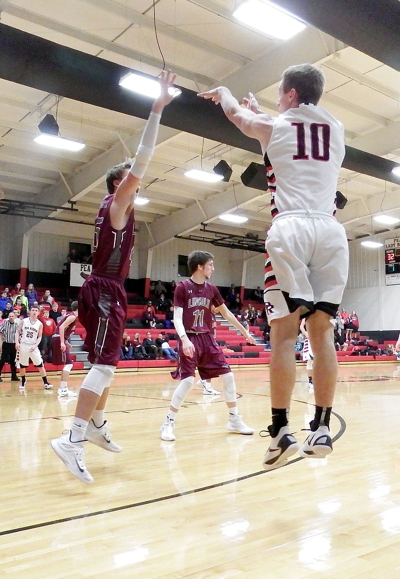 Junior Blackhawk Cole Wright leapt for a 3-point shot Thursday night during the Blackhawks&#8217; contest against Lincoln Wolves.