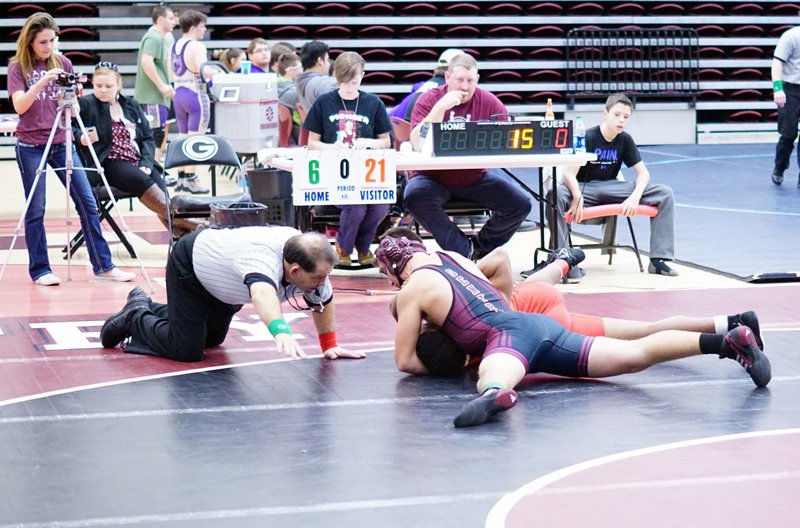 Matthew Nance waits for the call as he holds his opponent in a near-fall and works for the pin during the Pioneer Holiday Classic wrestling tournament held in Gentry on Dec. 19.