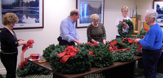 Submitted photo PREPARING WREATHS: Baseline-Meridian Chapter United States Daughters of 1812 members and spouses helped to ready 140 wreaths placed on Dec. 12 at the Arkansas Veterans Cemetery in North Little Rock. From left are Mary Ellen Laursen, John Ochsner, Valerie Hartnett, Sheila Beatty and Frankie Ochsner