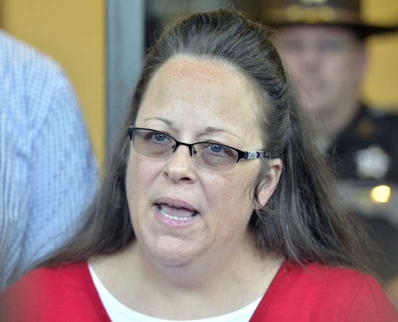 In this Sept. 14, 2015 file photo, Rowan County Clerk Kim Davis makes a statement to the media at the front door of the Rowan County Judicial Center in Morehead, Ky. when she announced that her office will issue marriage licenses under order of a federal judge, but will not have her name or office listed.