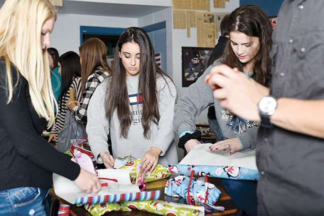Wrapping tiaras for the little girls in the Central Arkansas Development Council’s Head Start Program at Shannon Hills are Bryant High School Student Senate members, from left, Blakelee Gray, Ashton Kimbrough and Alexis Loria. Members of the Student Senate bought and wrapped presents for 17 children.
