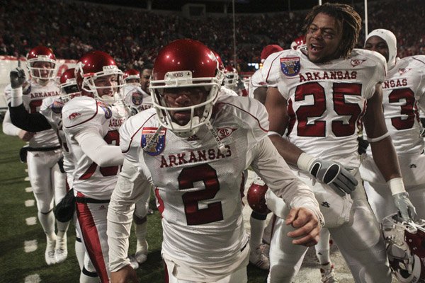Arkansas kicker Alex Tejada is surrounded by teammates after kicking a game winning fieldgoal in over time to beat East Carolina 20-17 in the Liberty Bowl on Saturday, Jan. 2, 2010.