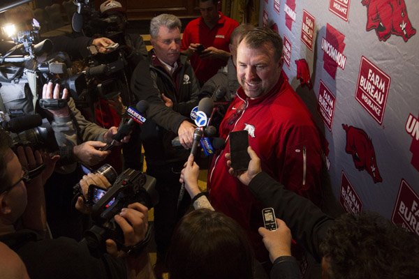 Arkansas coach Bret Bielema talks to the media after arriving at the Peabody Hotel in Memphis with his team Monday, Dec. 28, 2015, in preparation for the Liberty Bowl.