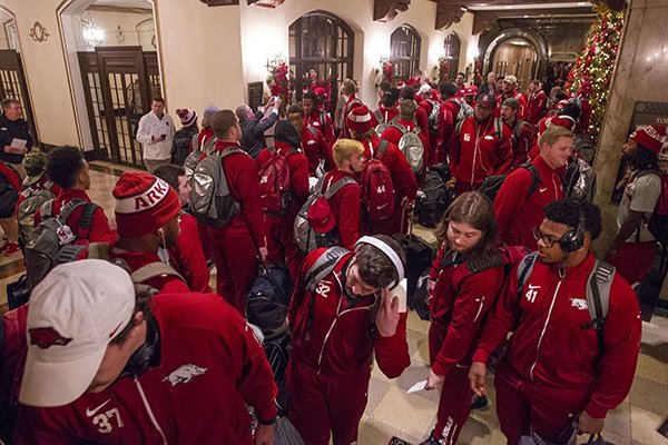 Arkansas players walk in to the Peabody Hotel on Monday, Dec. 28, 2015, in Memphis, Tenn. 