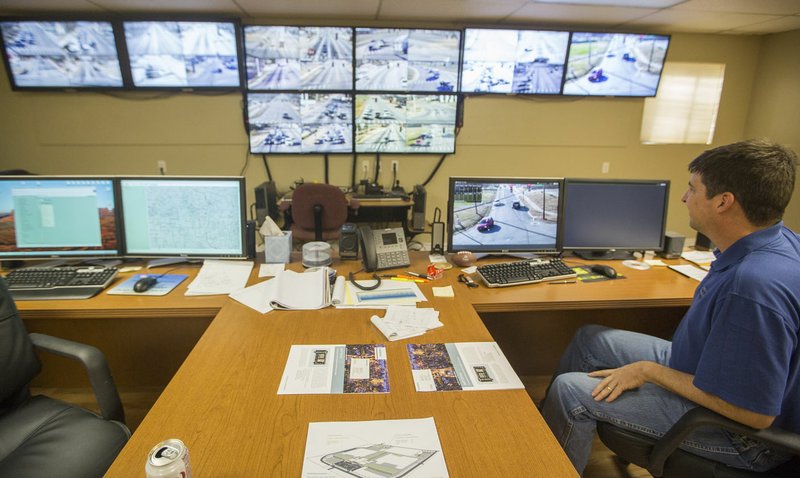 Brad Conley, a traffic technician, monitors cameras Dec. 10 inside the Bentonville Traffic Management Center. The center features eight 46-inch televisions, which monitor 38 of the city’s signalized intersections. For more photos, go to www.nwadg.com/photos.