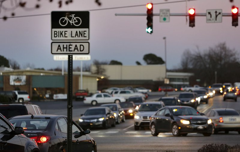 Traffic begins to back up Dec. 3 at the intersection of Rolling Hills Drive and College Avenue in Fayetteville during the 5 p.m. rush hour. Only 3.4 percent of the region’s workforce telecommuted in 2010, well below the national average, according to the U.S. Census Bureau