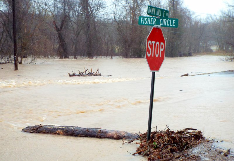 Photo by Randy Moll Flint Creek overflowed its banks and the roadway just north of the Ozark Adventist Academy on Sunday afternoon.