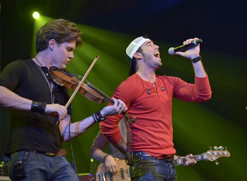 Vocalist Craig Strickland (right) and Eric Dysart perform in April as the Fayetteville band Backroad Anthem plays a set at the FLW Expo on the final day of the Walmart FLW Tour at Beaver Lake at the John Q. Hammons Center in Rogers .