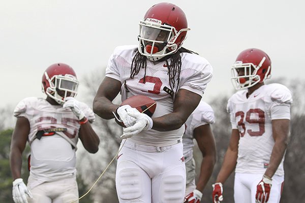 Arkansas running back Alex Collins goes through practice Tuesday, Dec. 29, 2015, at Rhodes College in Memphis, Tenn. 