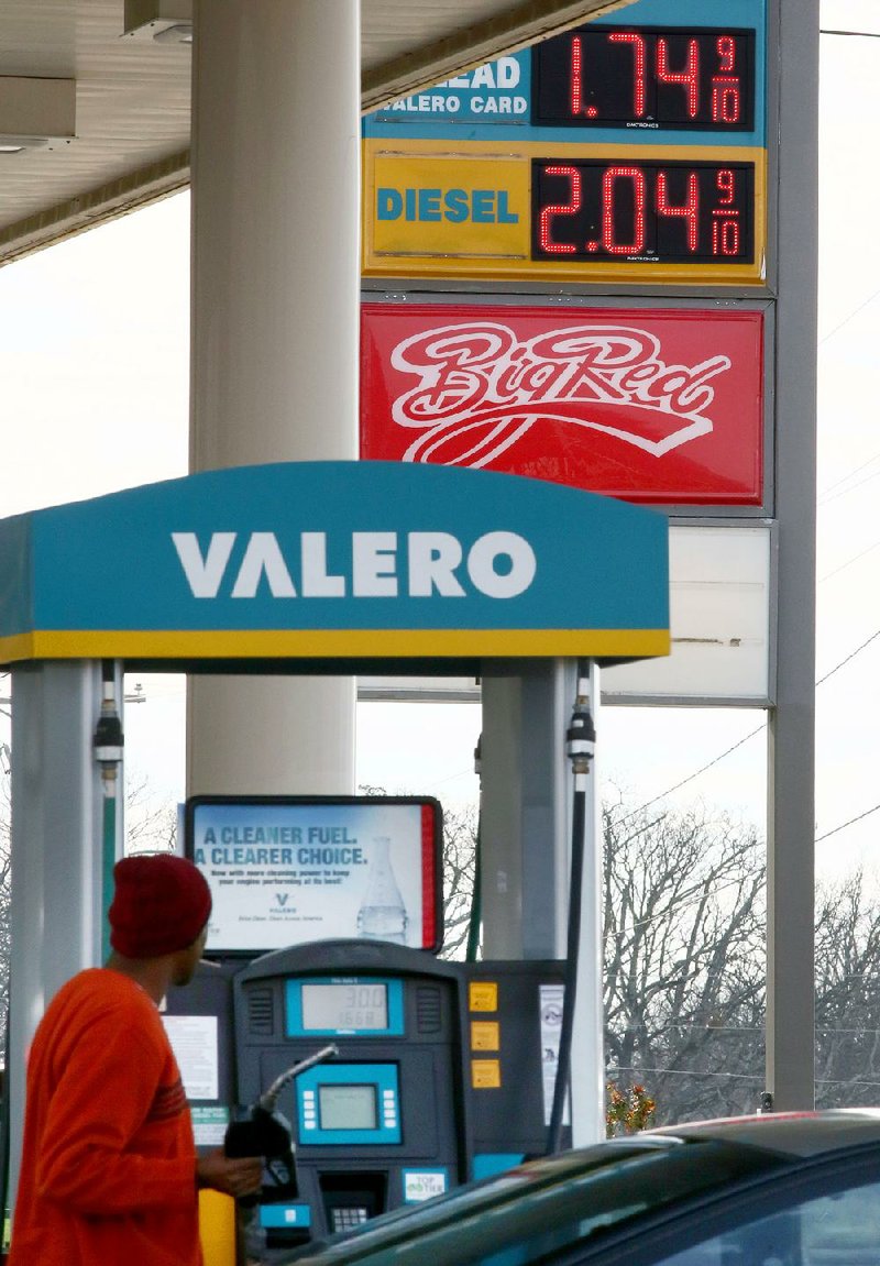A motorist pumps gas Thursday at a gas station on Fair Park Boulevard in Little Rock. 