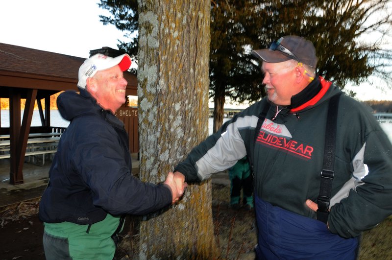 J.R. Beehler (left) and Rickey Searcy celebrate Friday after winning the annual Polar Bear Bass Tournament at Beaver Lake. They weighed five bass totaling 14.41 pounds.