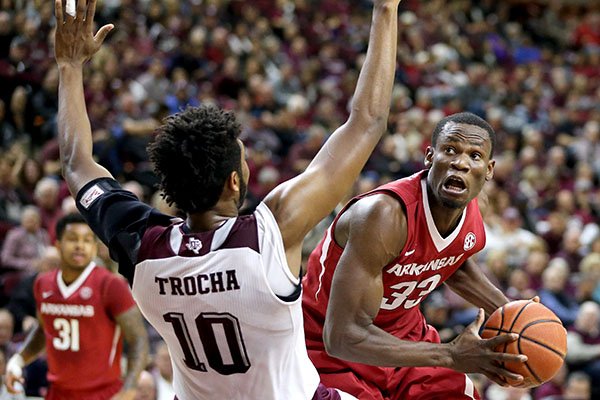 Arkansas' Moses Kingsley (33) drives the lane for a basket against Texas A&M's Tonny Trocha-Morelos (10) during the first half of an NCAA college basketball game Saturday, Jan. 2, 2016, in College Station,Texas. (AP Photo/Sam Craft)
