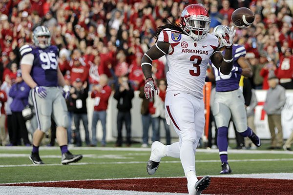 Arkansas running back Alex Collins (3) scores a touchdown on a 13-yard run against Kansas State in the first half of the Liberty Bowl NCAA college football game Saturday, Jan. 2, 2016, in Memphis, Tenn. (AP Photo/Mark Humphrey)
