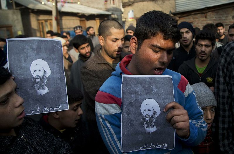 A Kashmiri Shiite holds a portrait of Saudi-executed cleric Nimr al-Nimr during a protest Saturday in Srinagar in the India-controlled Kashmir state. Hundreds of mourners turned out for the demonstration. 
