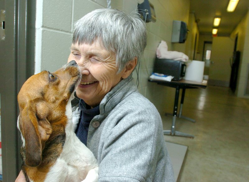 In this Dec. 2, 2005, file photo, Lib Horn cuddles with one of the seven dogs brought to the Fayetteville Animal Shelter after being rescued from an animal sanctuary in Baxter County.