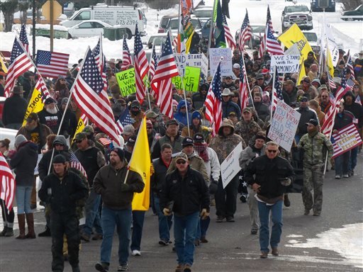 Protesters march on Court Avenue in support of an Oregon ranching family facing jail time for arson in Burns, Ore., Saturday, Jan. 2, 2016. Family members were convicted of the arsons three years ago and served time. But a judge ruled their terms were too short under federal law and ordered them back to prison for about four years each. (Les Zaitz/The Oregonian via AP) MAGS OUT; TV OUT; NO LOCAL INTERNET; THE MERCURY OUT; WILLAMETTE WEEK OUT; PAMPLIN MEDIA GROUP OUT; MANDATORY CREDIT