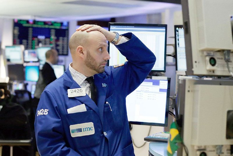Specialist Meric Greenbaum works Monday on the fl oor of the New York Stock Exchange. Stocks fell sharply at U.S. markets on the first day of trading in 2016.
