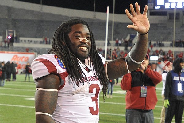 Arkansas running back Alex Collins waves to fans as he leaves the field following a game against Kansas State on Saturday, Jan. 2, 2016, at Liberty Bowl Memorial Stadium in Memphis, Tenn. 