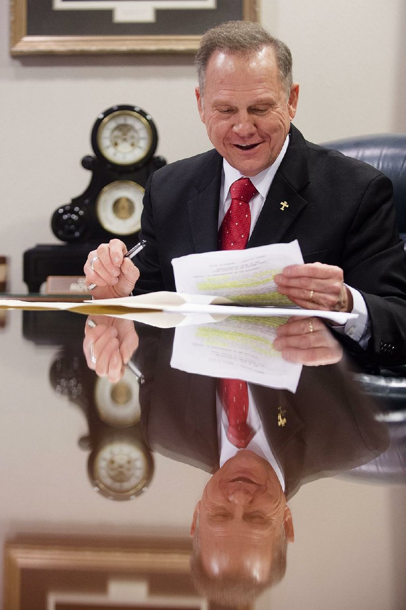 Alabama Chief Justice Roy Moore, on Wednesday in Montgomery, reads his administrative order discouraging probate judges from issuing marriage licenses to same-sex couples. 