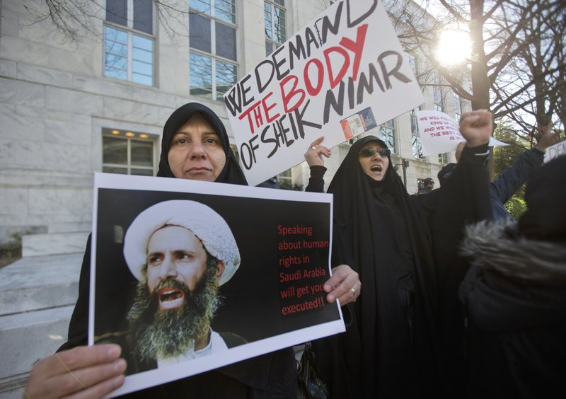 Amel Al-Hajjar, left, and Khadija Falih, both from Iraq, participate in a rally in front of the Saudi Arabian embassy in Washington, Tuesday, Jan. 5, 2016, to protest the mass executions in Saudi Arabia.