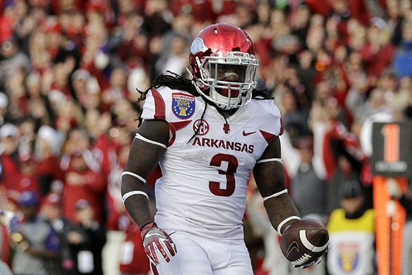 Arkansas running back Alex Collins (3) scores a touchdown against Kansas State in the first half of the Liberty Bowl NCAA college football game Saturday, Jan. 2, 2016, in Memphis, Tenn. (AP Photo/Mark Humphrey)
