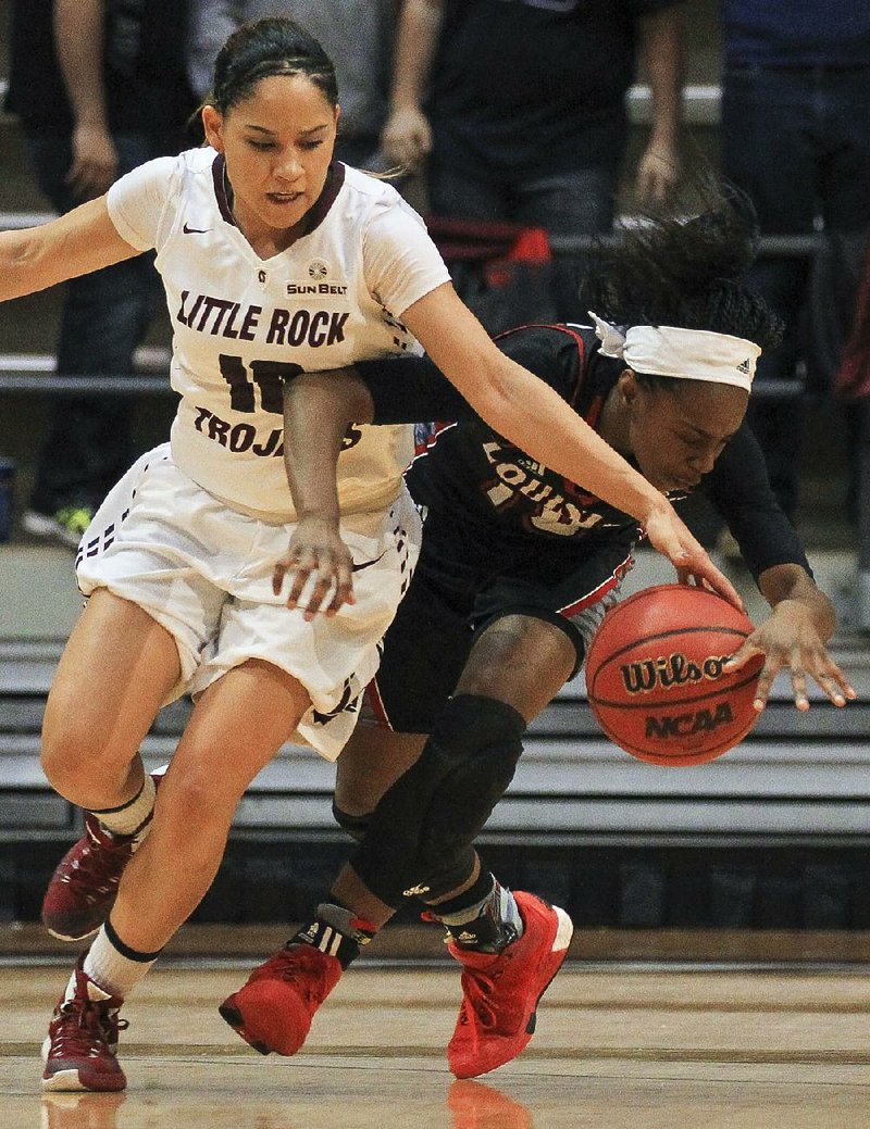 UALR’s Alexius Dawn (left) and Louisiana-Lafayette’s Kia Wilridge chase down a loose ball during the Trojans’ 65-58 loss to the Ragin’ Cajuns on Thursday at the Jack Stephens Center. It was the Trojans’ first home loss to a Sun Belt team since losing to Florida International on Jan. 12, 2013.