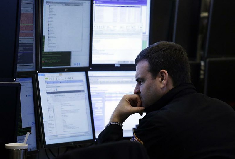 A trader follows stock prices Friday at the New York Stock Exchange. The Dow Jones industrial average and the Standard & Poor’s 500 both fell about 6 percent this week. 