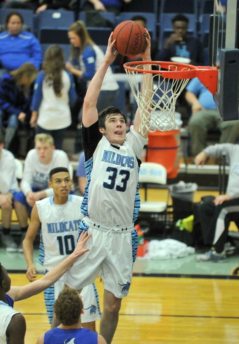 JP Brandon of Springdale Har-Ber goes up for the dunk during Friday’s game against Rogers. The Wildcats won 73-53.