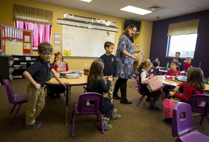  Jenne Rodgers, first-grade teacher, gets her students ready for lunch Thursday at Providence Academy in Rogers.