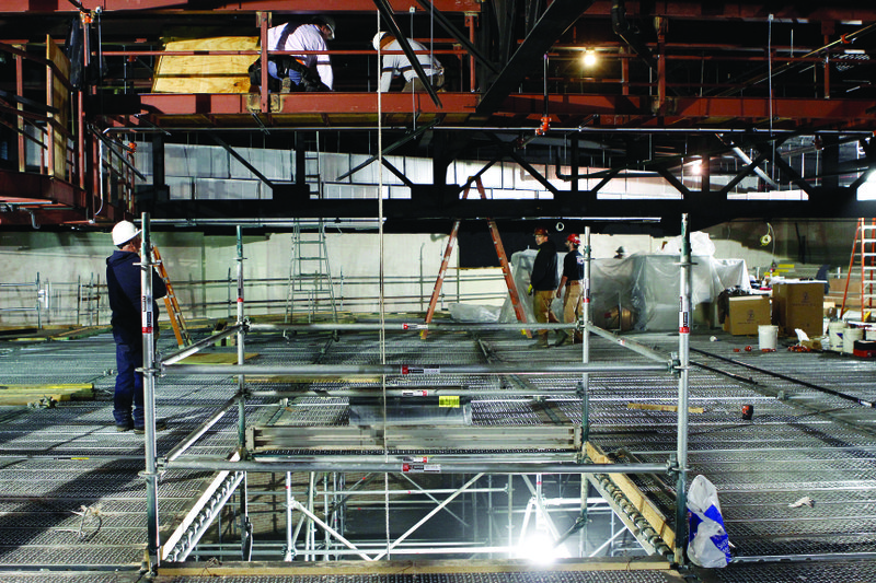 Construction: Men at the El Dorado Municipal Auditorium work atop scaffold during a large renovation project. The project was approved by the El Dorado City Council in June of last year.